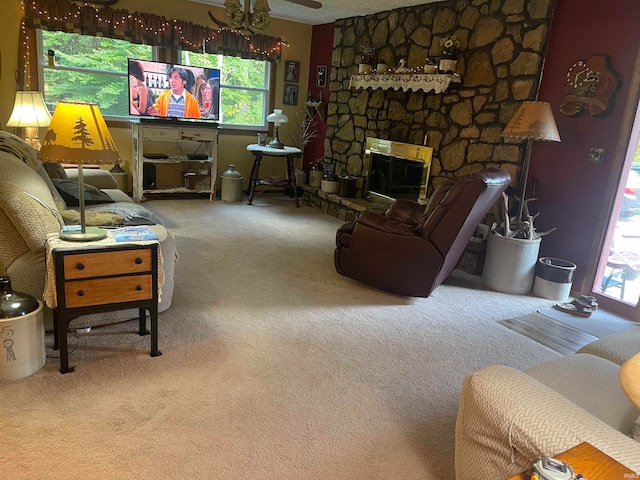 living room featuring carpet and a stone fireplace