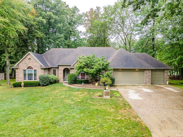 ranch-style house featuring a garage and a front yard