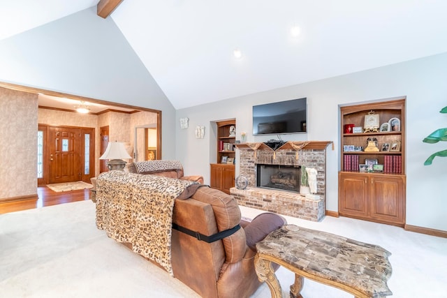 living room featuring a brick fireplace, built in shelves, beamed ceiling, and light wood-type flooring