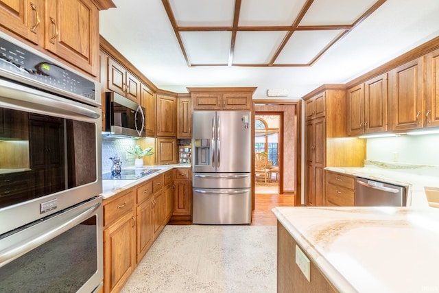 kitchen with appliances with stainless steel finishes and decorative backsplash