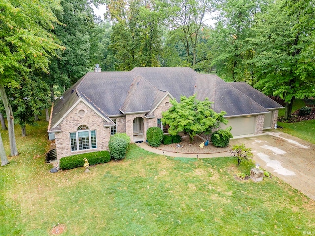 view of front of home with a front yard and a garage