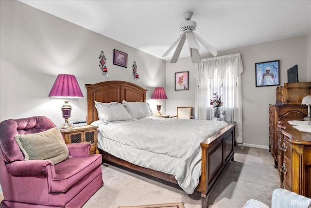 bedroom with ceiling fan and light colored carpet