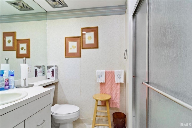 bathroom featuring tile patterned flooring, a shower with shower door, vanity, and toilet