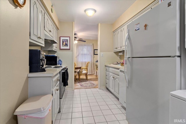 kitchen with white cabinetry, electric range oven, light tile patterned floors, ceiling fan, and refrigerator