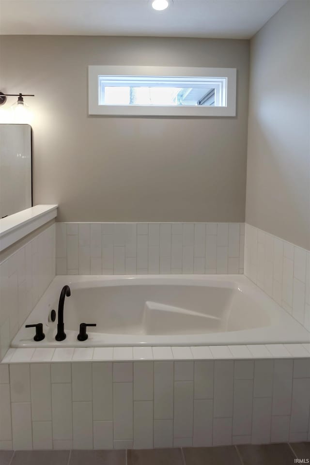 bathroom with a relaxing tiled tub