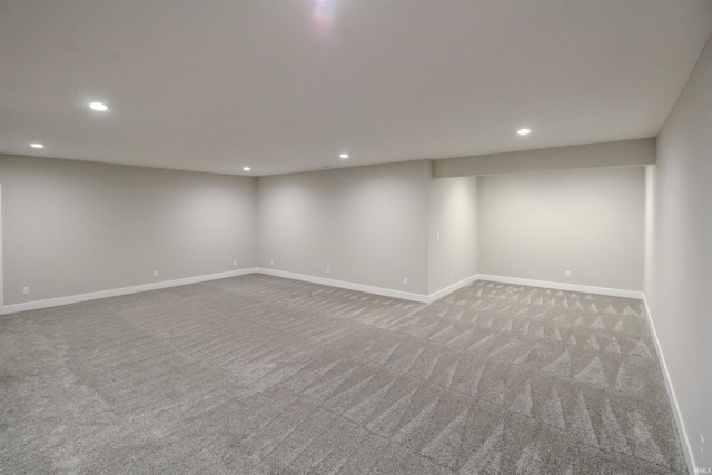 finished basement with light carpet, recessed lighting, and baseboards