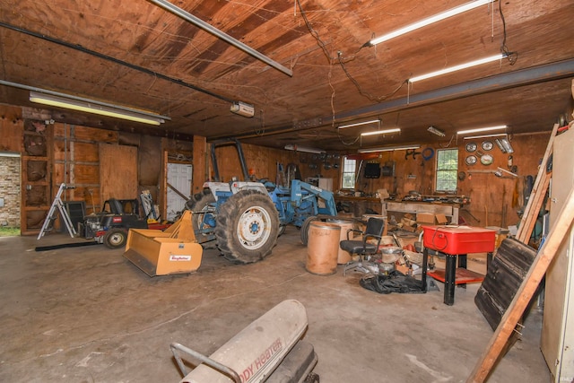 garage with wood walls and a workshop area