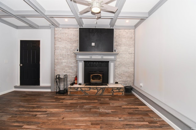 unfurnished living room featuring ceiling fan, coffered ceiling, a fireplace, and dark hardwood / wood-style flooring