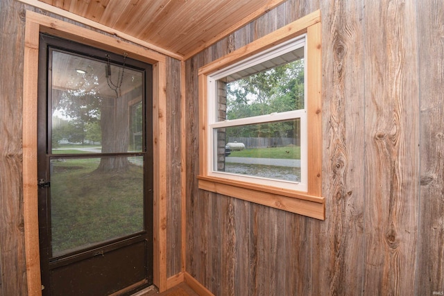 interior space featuring wood walls and wooden ceiling