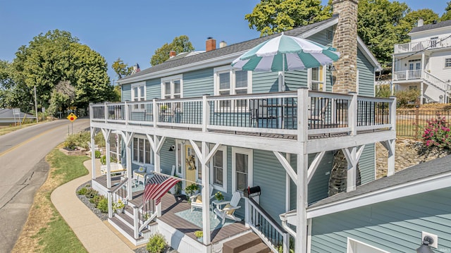 back of property featuring a deck