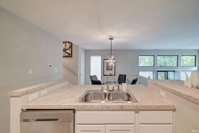 kitchen featuring a chandelier, sink, white cabinetry, hanging light fixtures, and dishwashing machine