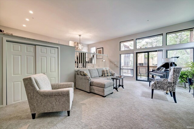 living room featuring an inviting chandelier and light carpet