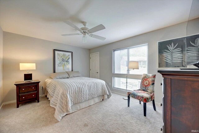 bedroom featuring ceiling fan, light colored carpet, and a closet