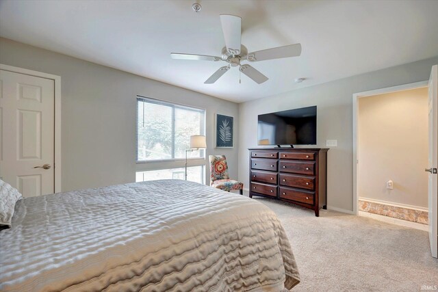 bedroom with ceiling fan and light colored carpet