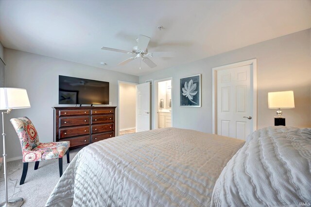 carpeted bedroom with ceiling fan and ensuite bathroom