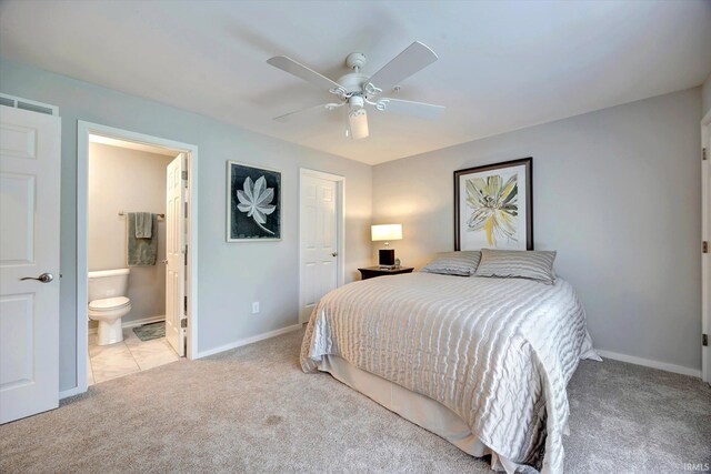 bedroom featuring connected bathroom, ceiling fan, and light colored carpet