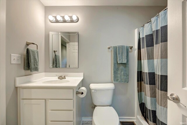 bathroom with vanity, toilet, and a shower with curtain