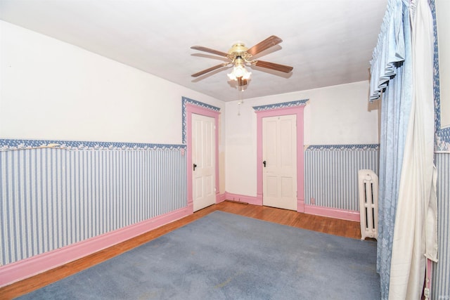 unfurnished room featuring ceiling fan and wood-type flooring