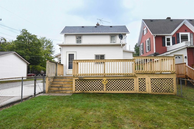 back of property with a wooden deck and a lawn