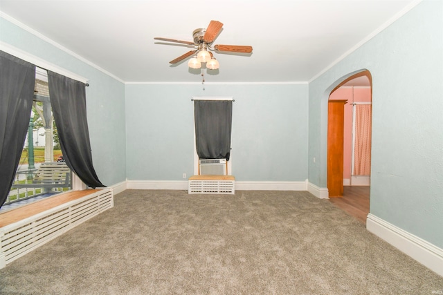 carpeted empty room featuring ornamental molding and ceiling fan