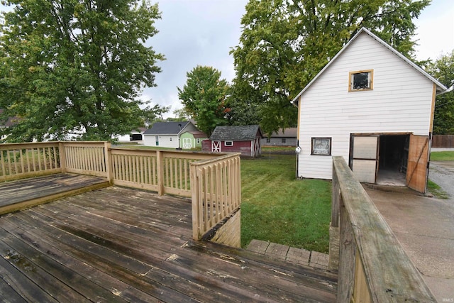 wooden deck featuring a storage shed and a lawn