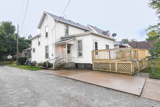 rear view of house with a wooden deck