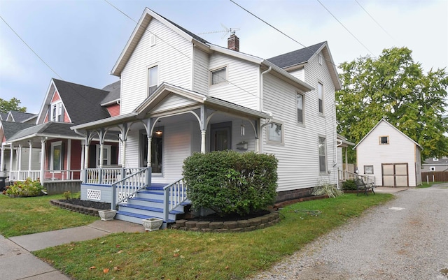 view of front facade featuring a front lawn, a porch, and a shed