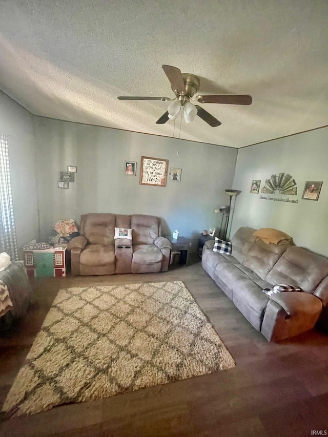 unfurnished living room with ceiling fan, a textured ceiling, and wood-type flooring