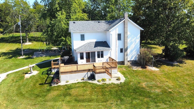 exterior space with a deck and a lawn