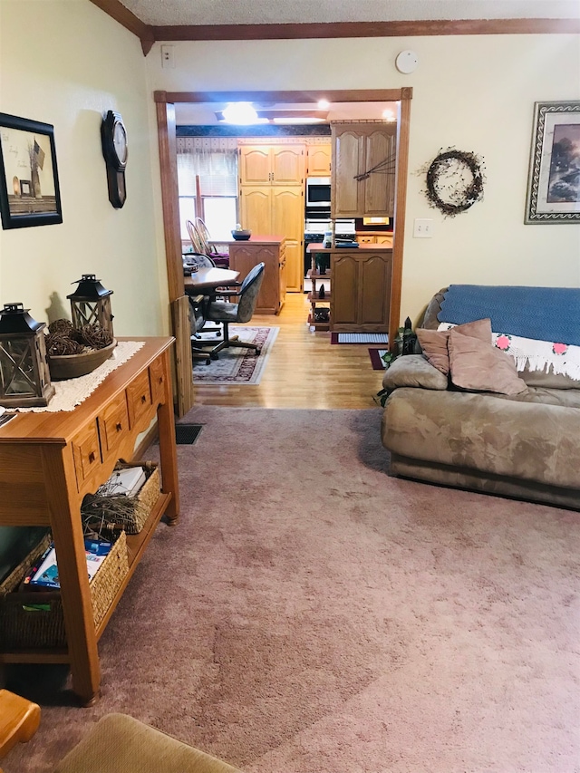 living room featuring hardwood / wood-style flooring and ornamental molding