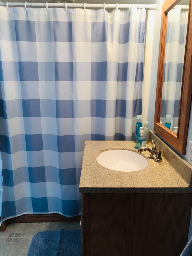 bathroom featuring tile patterned flooring and vanity