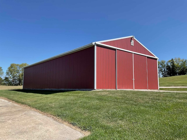 view of outdoor structure featuring a lawn