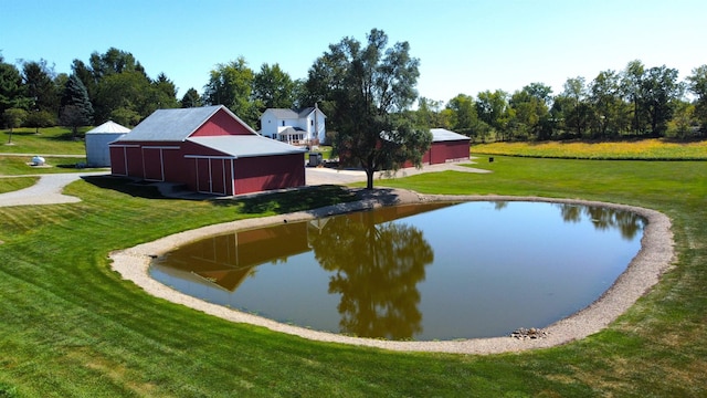 view of home's community featuring a yard and an outbuilding