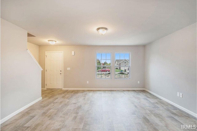 spare room with light hardwood / wood-style flooring