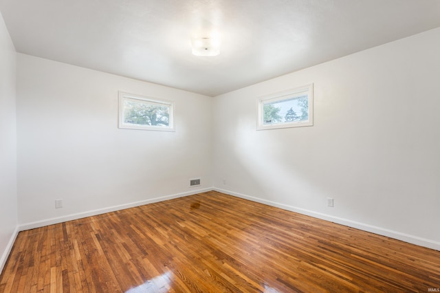 unfurnished room with wood-type flooring