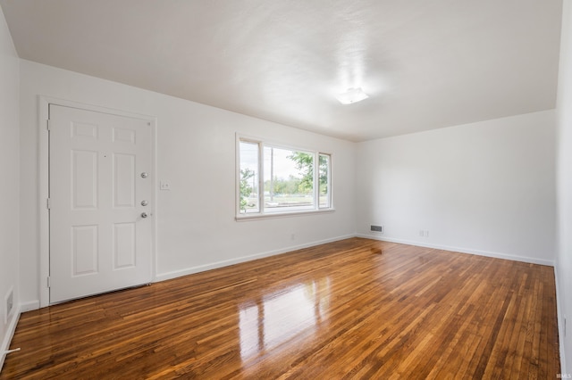 empty room with hardwood / wood-style flooring