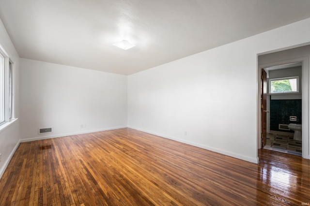 spare room featuring dark hardwood / wood-style floors