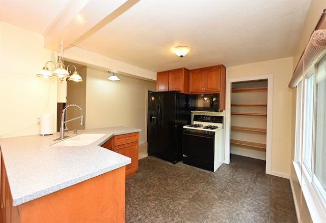 kitchen featuring sink, kitchen peninsula, an inviting chandelier, black appliances, and decorative light fixtures