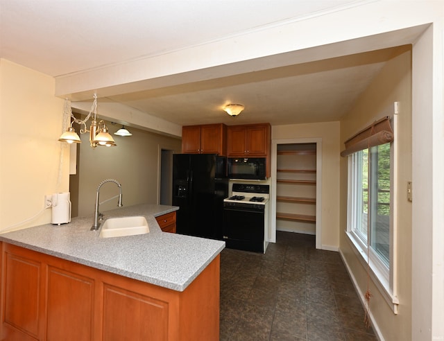 kitchen featuring pendant lighting, sink, a notable chandelier, kitchen peninsula, and black appliances