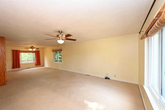 spare room featuring ceiling fan and light colored carpet