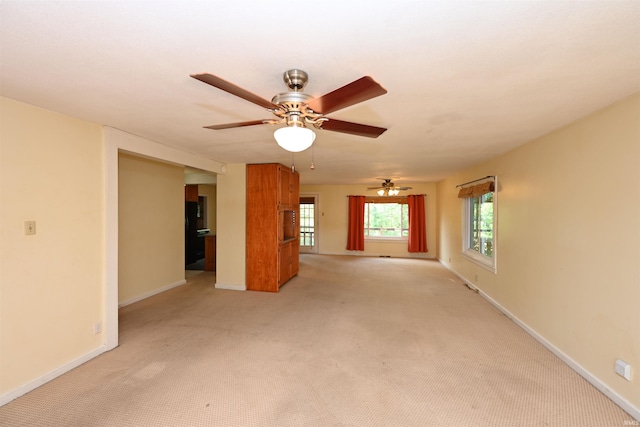 unfurnished living room with light carpet and ceiling fan