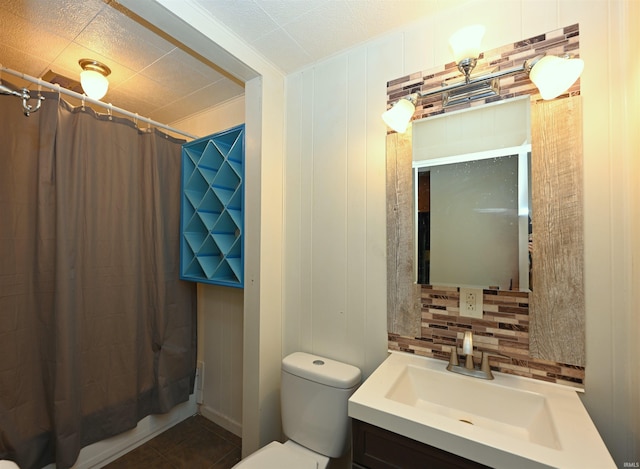 full bathroom with shower / bath combo with shower curtain, tasteful backsplash, vanity, toilet, and tile patterned floors