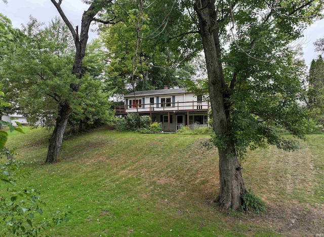 view of front of house featuring a front yard and a deck