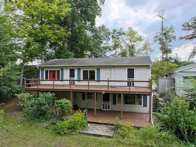 rear view of house featuring a deck