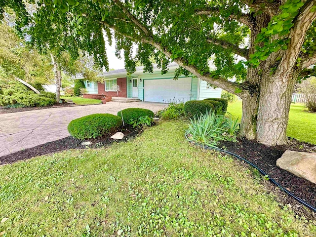 ranch-style home with a garage and a front lawn