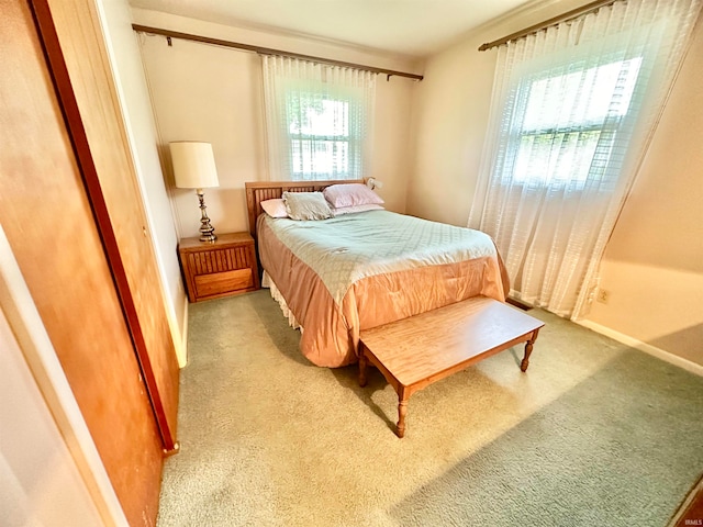 carpeted bedroom featuring multiple windows