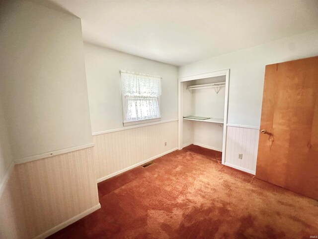 unfurnished bedroom featuring a closet and carpet flooring