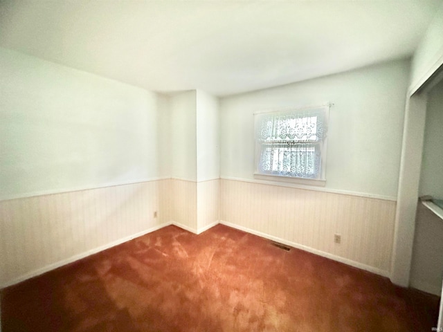 unfurnished room featuring carpet flooring