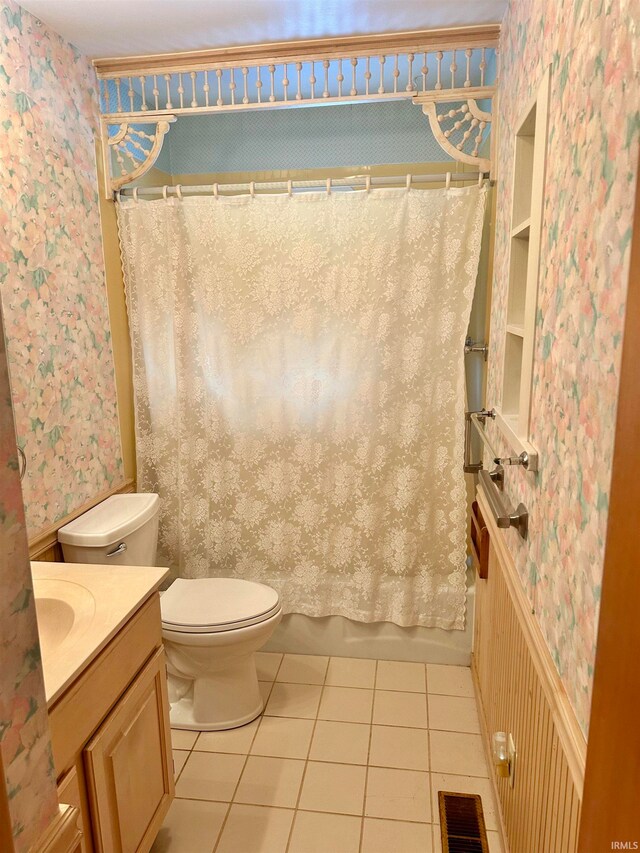 full bathroom with vanity, tile patterned floors, toilet, and shower / tub combo with curtain