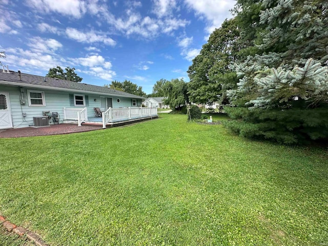 view of yard with a patio, a deck, and central air condition unit